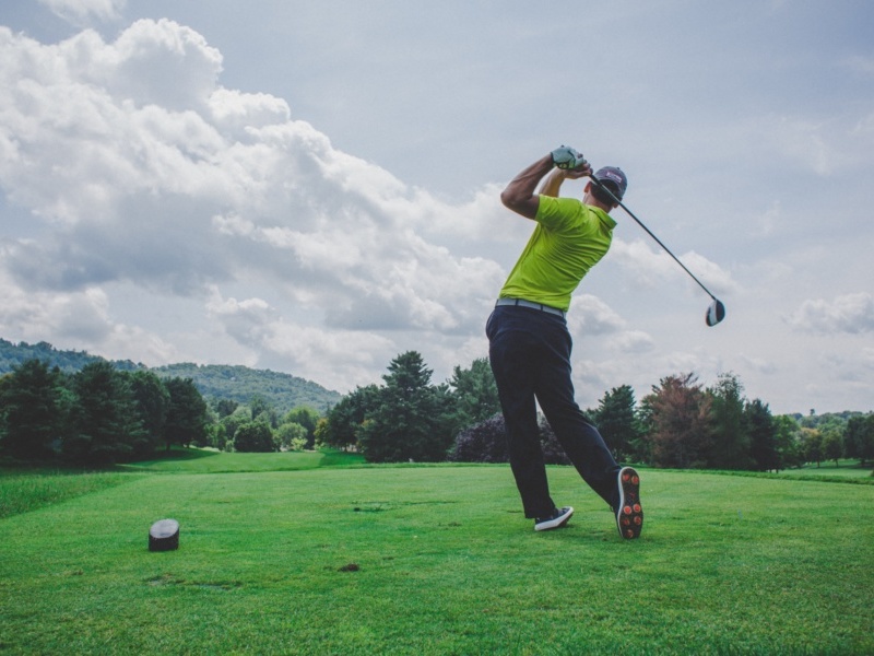 Golfer teeing off