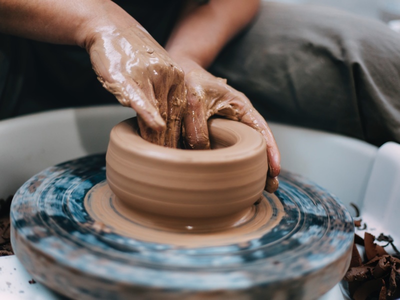 Turning pottery on wheel